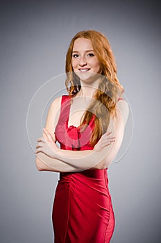 Girl in red dress against gray