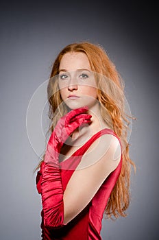 Girl in red dress against gray