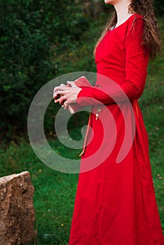 Girl in a red dress with a book