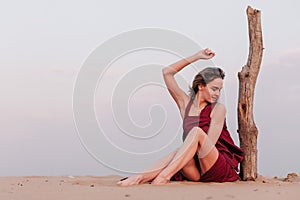 Girl in a red dress in the desert