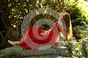 Girl in red dress in forest