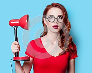 Girl in red dress with lamp