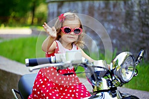 Girl in a red dress on a motorcycle