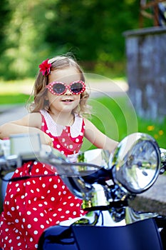 Girl in a red dress on a motorcycle