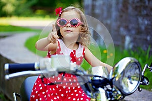 Girl in a red dress on a motorcycle