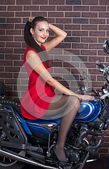 Girl in red dress on a motorcycle