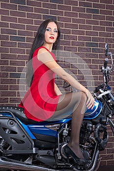 Girl in red dress on a motorcycle