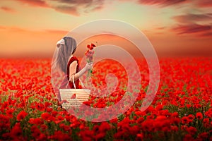 Girl in a red dress on a poppy field