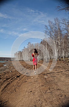 Girl in red dress walking