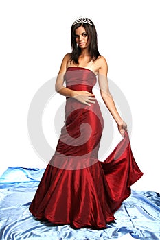 Girl in an red evening dress and with a diadem