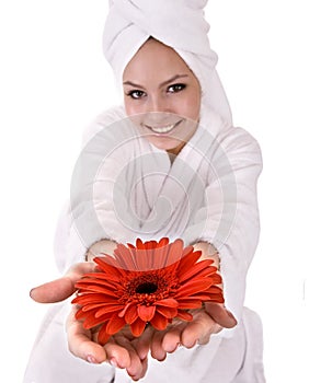 Girl with red flower and white towel on head .