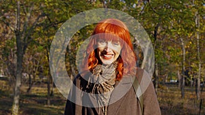 girl with red hair in autumn park