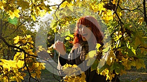 girl with red hair in autumn park