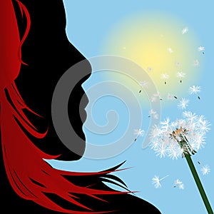 Girl with red hair blowing over dandelion