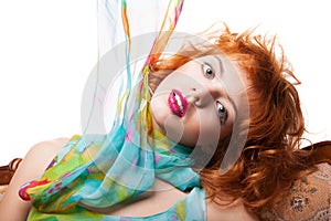 Girl with red hair and colorful dress over white