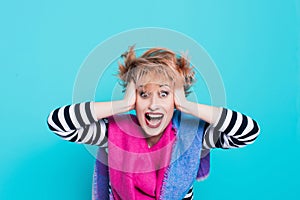 Girl with red hair holding her head shouting. Stress and hysterical. negative emotions. Studio shot.