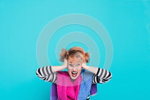 Girl with red hair holding her head shouting. Stress and hysterical. negative emotions. Studio shot.