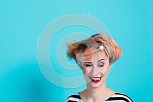 Girl with red hair holding her head shouting. Stress and hysterical. negative emotions. Studio shot.