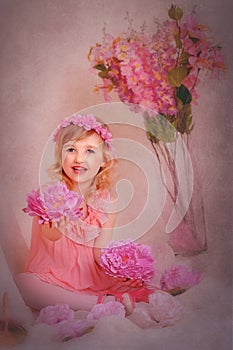 Girl with red hair in a pink dress and with flowers