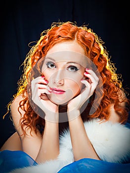 Girl with red hair wearing white fur on black