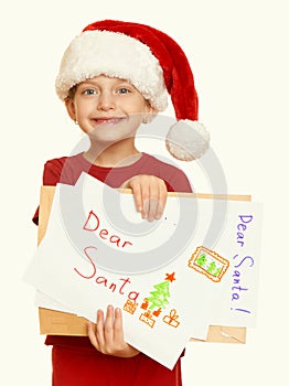 Girl in red hat with letter to santa - winter holiday christmas concept, yellow toned