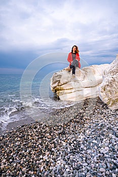 girl in a red jacket on the seashore