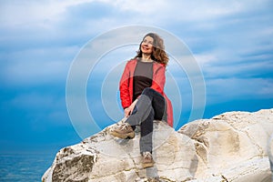 girl in a red jacket on the seashore