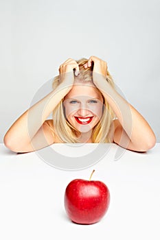 Girl with red lips and a red apple