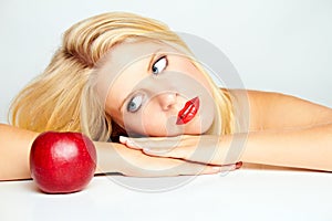 Girl with red lips and a red apple