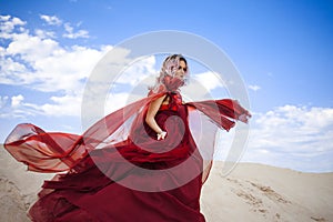 Girl in red. Outgoing young woman in a scarlet dress flying