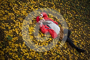 The girl in red overlie with ginkgo leaf