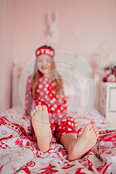 Girl in red pajamas sleeping in bed