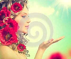 Girl with red poppy flowers hairstyle