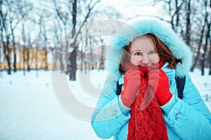 Girl in red scarf in park on a cold winter day