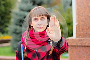 Girl in a red scarf stops her hand