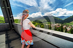 Girl in red skirt looking from lookout tower called Heart of Terchova in Slovakia