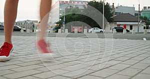 Girl in red trainers dancing on pavement