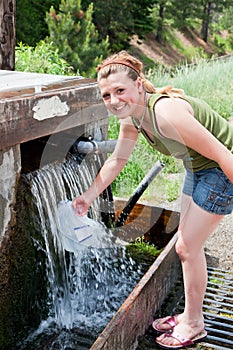 Girl Refilling a Water Jug