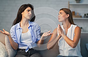 Girl Refusing To Do Favor For Friend Sitting On Sofa