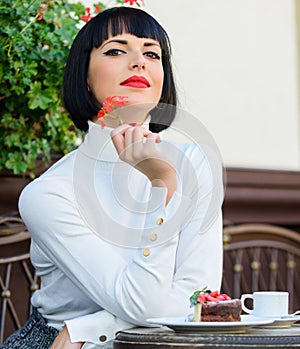 Girl relax cafe with cake dessert. Woman attractive elegant brunette eat gourmet cake cafe terrace background. Gourmet