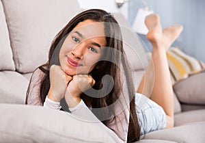 Girl relaxation at home on comfortable sofa