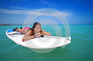 Girl relaxed lying on paddle surf board SUP