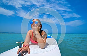 Girl relaxed lying on paddle surf board SUP