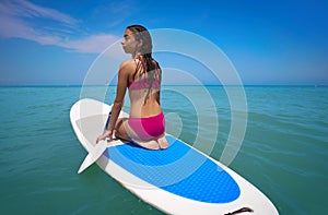 Girl relaxed on paddle surf board SUP