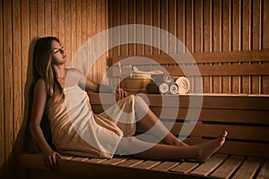 The girl relaxes in a sauna