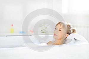 Girl relaxing in bathtub