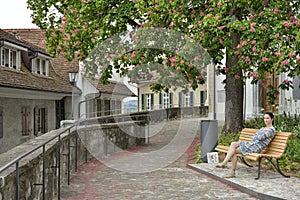 Girl relaxing on bench in a dreaming place from Thun