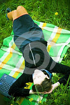 Girl relaxing on blanket outdoors