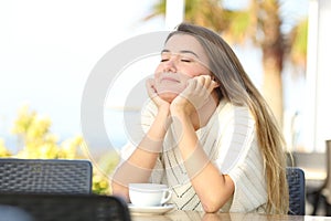 Girl relaxing with closed eyes in a coffee shop terrace