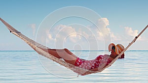 Girl relaxing in a hammock on tropical island beach. Summer vacation in Punta Cana, Dominican Republic